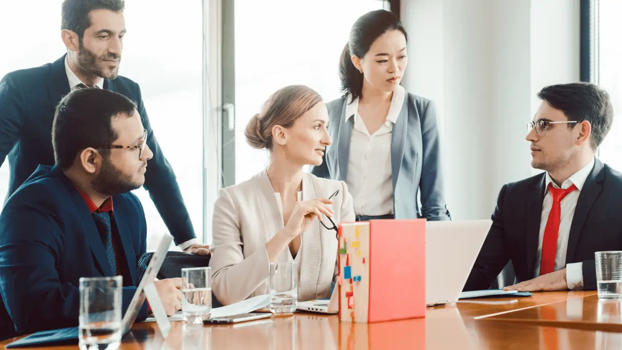 Legal marketing team discussing strategies to turn website traffic into legal leads during conference meeting