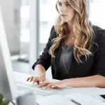 Attorney creating practice area SEO content on computer for law firm digital marketing strategy