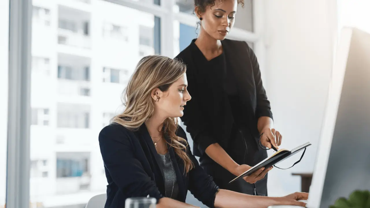 Two attorneys implementing blog strategy for legal SEO at modern law firm office