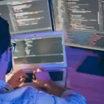 Attorney reviewing long-term legal SEO strategy implementation code on multiple computer monitors